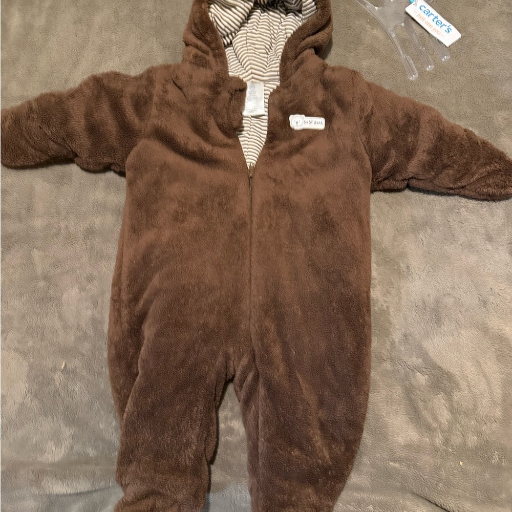 Brown bear out for winter in pretend brown coat sleeper and White Striped Fabric